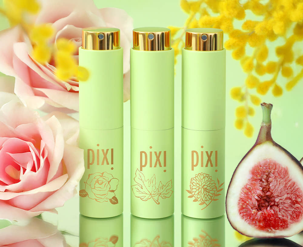 PixiPerfume shown in Rose, Fig, and Mimosa scents with flowers showing in background