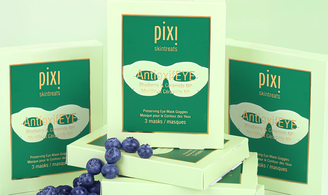 AntioxifEYE Eye Mask Goggles shown on a green background with blueberries