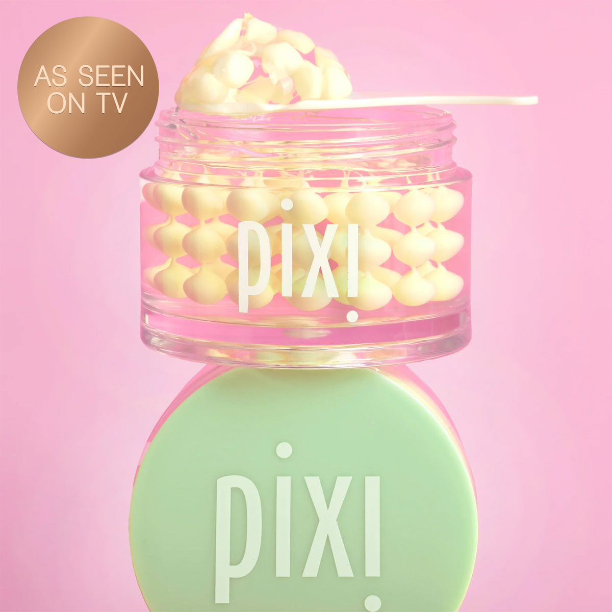 Pixi Vitamin-C CreamSerum product with pink lid and green cap on a pink background and a "As Seen on TV" badge

Close-up texture of vitamin C serum cream