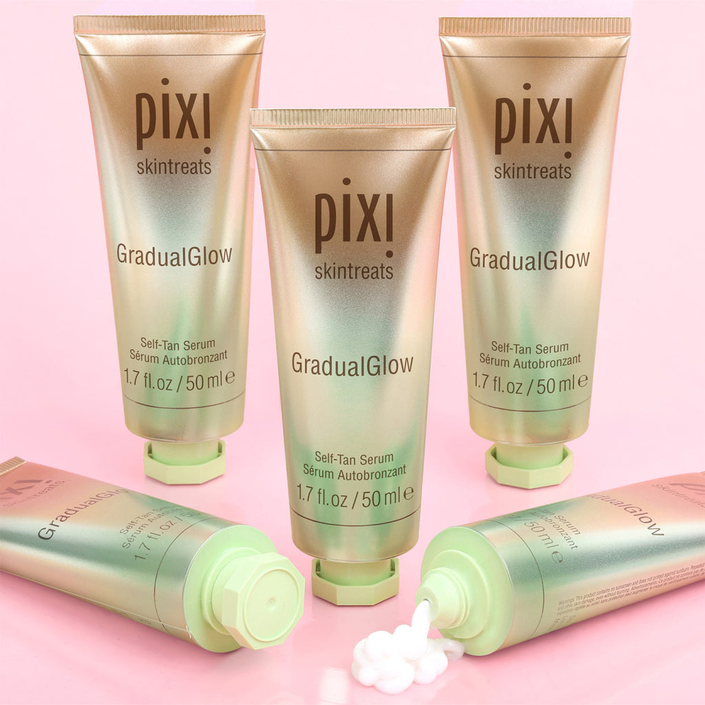 Pixi Gradual Glow self-tan serum tubes on a pink background