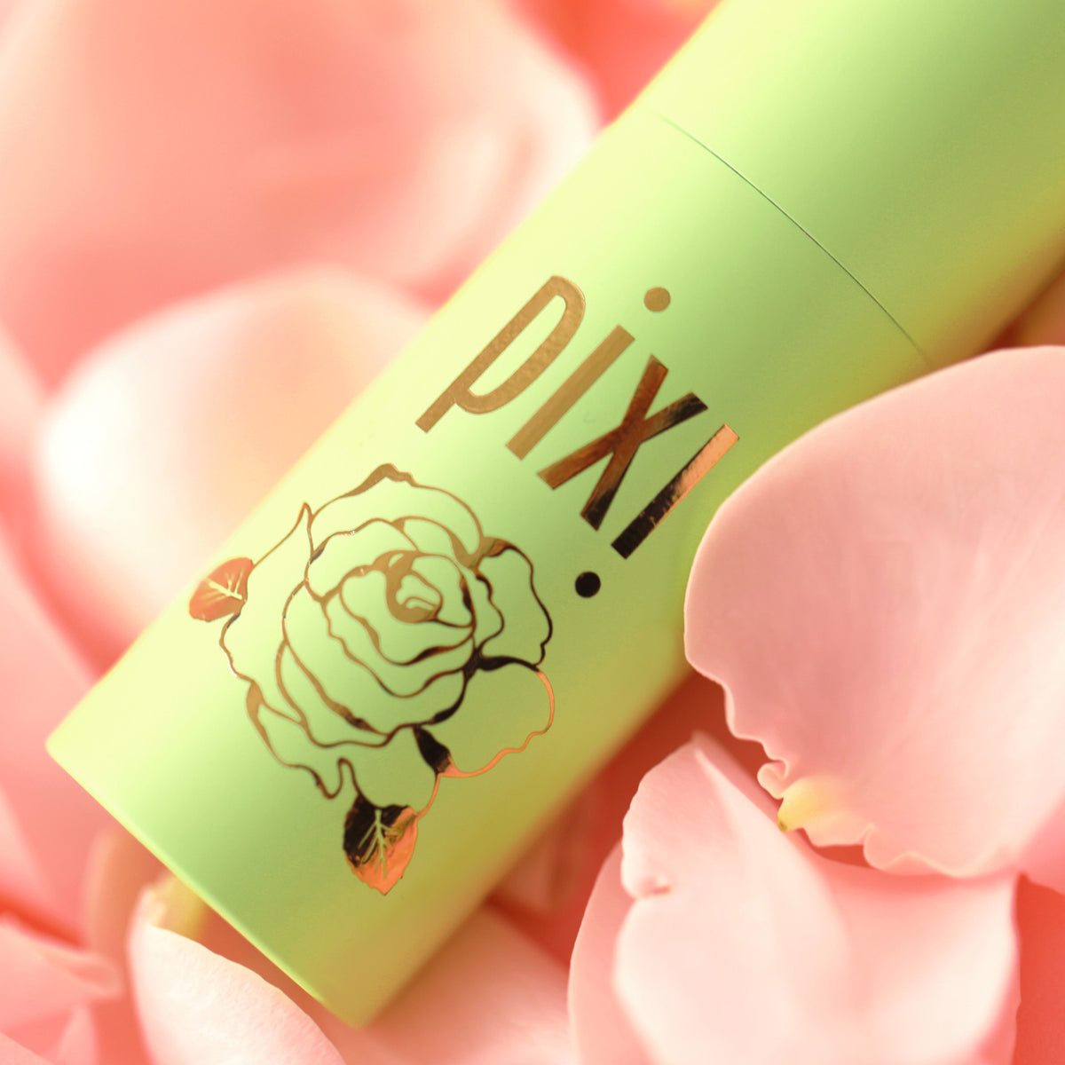 Close up of design detail on PixiRose Perfume showing a rose design on a pink background