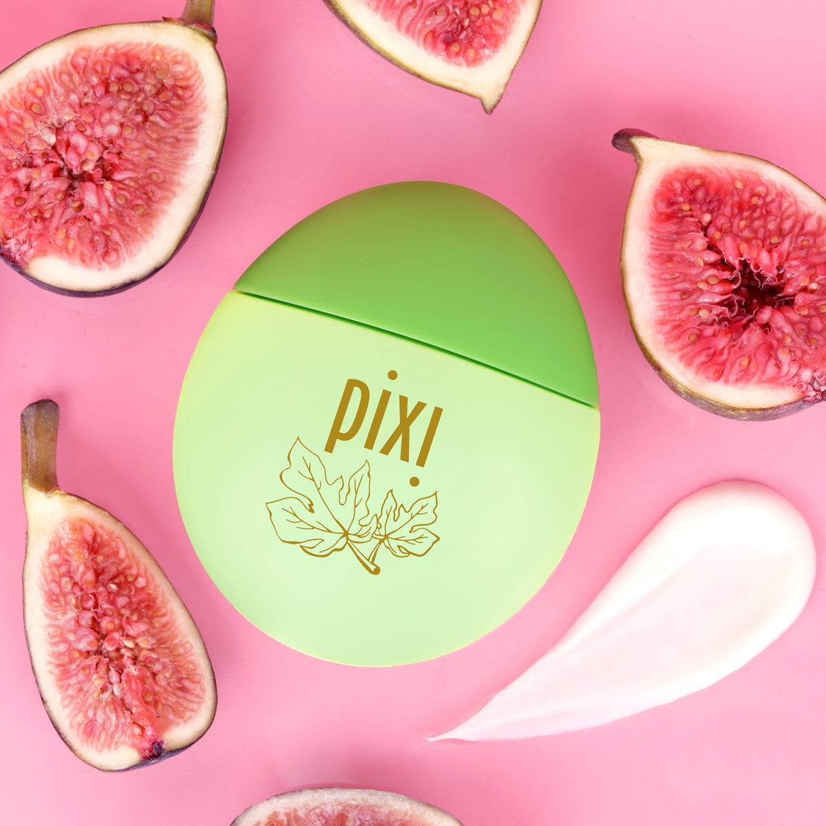 Pixi HandHero PixiFig scented hand lotion surrounded by fresh figs, including a swatch to show texture on a pink background.